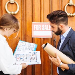 Real estate buyers checking home plans for sale