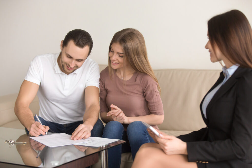 Home buyers reviewing offer with real estate agent in San Jose CA